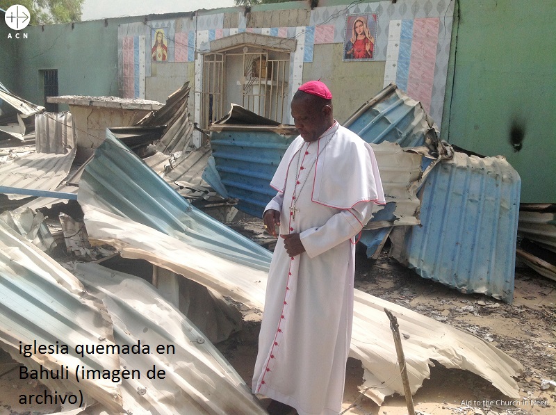 Nigeria bispo Oliver Dashe Doeme inspeccionando una iglesia quemada en Bahuli con texto